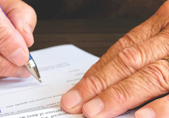 closeup of man's hands writing